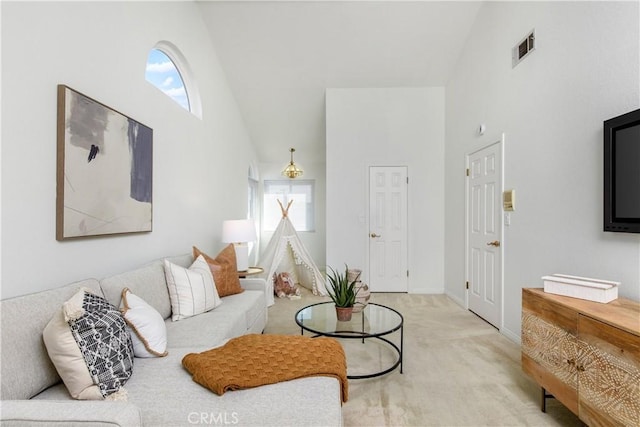 carpeted living room featuring high vaulted ceiling