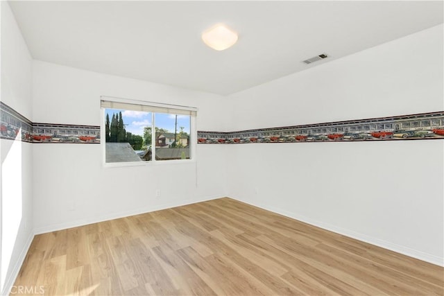 empty room with light hardwood / wood-style flooring