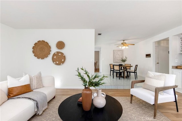 living room with hardwood / wood-style floors and ceiling fan