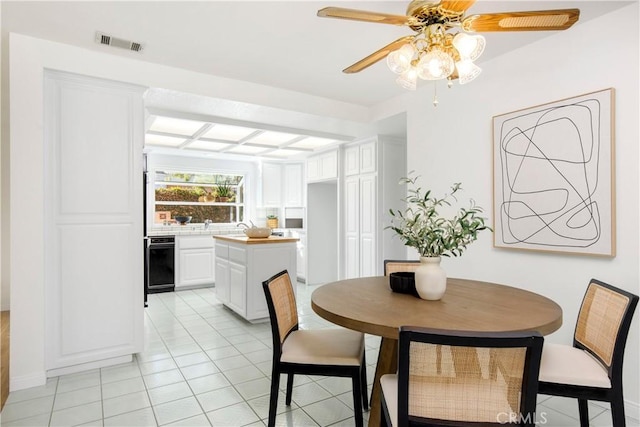 dining area featuring ceiling fan and light tile patterned flooring