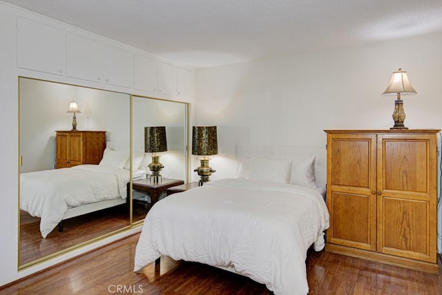 bedroom featuring a closet and hardwood / wood-style flooring