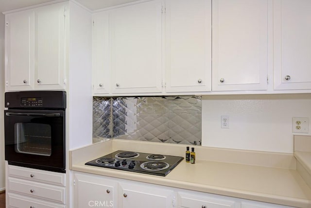 kitchen featuring backsplash, white cabinets, and black appliances