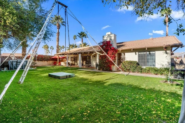 rear view of house with a yard