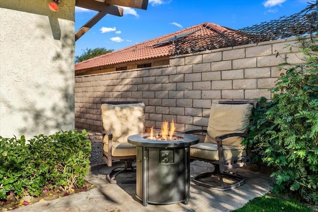 view of patio / terrace featuring an outdoor fire pit