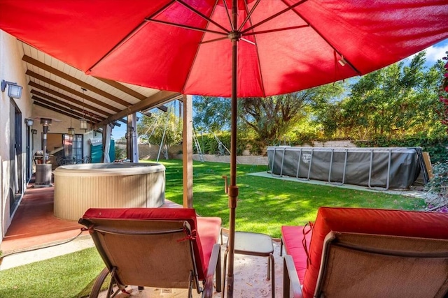 view of patio with a swimming pool with hot tub