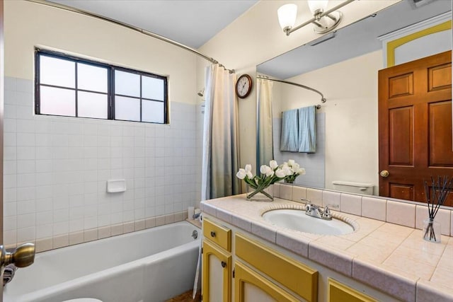 full bathroom with toilet, vanity, and shower / bath combo