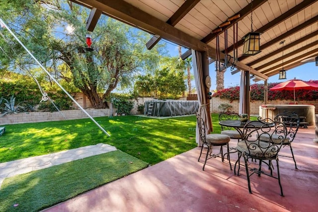 view of patio / terrace featuring a swimming pool with hot tub