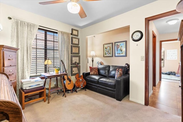 sitting room featuring light carpet and ceiling fan