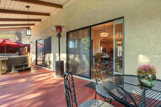 view of patio / terrace with a hot tub