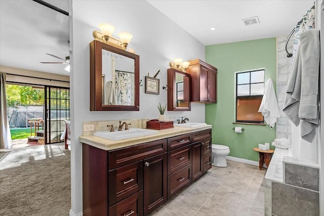 bathroom with ceiling fan, toilet, and vanity