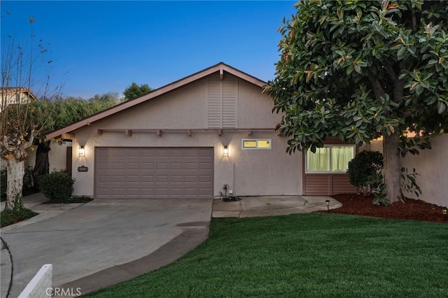 view of front of house with a lawn and a garage