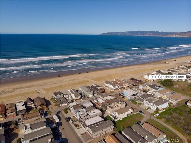 aerial view with a water view, a residential view, and a view of the beach