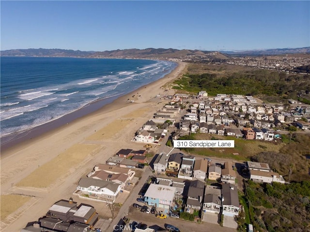 drone / aerial view with a water view, a residential view, and a view of the beach