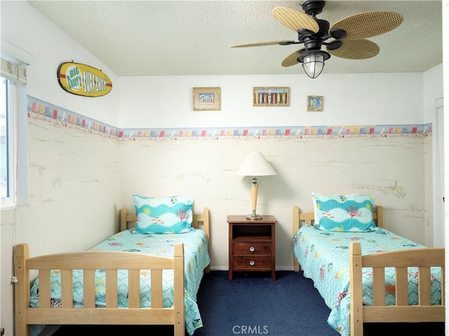 bedroom with carpet, ceiling fan, and a textured ceiling