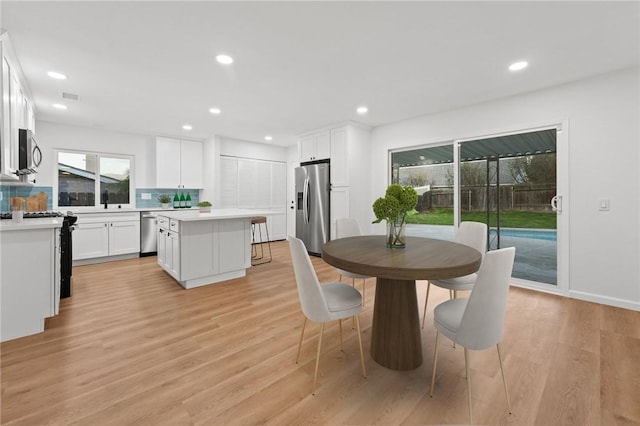 dining area with light hardwood / wood-style flooring