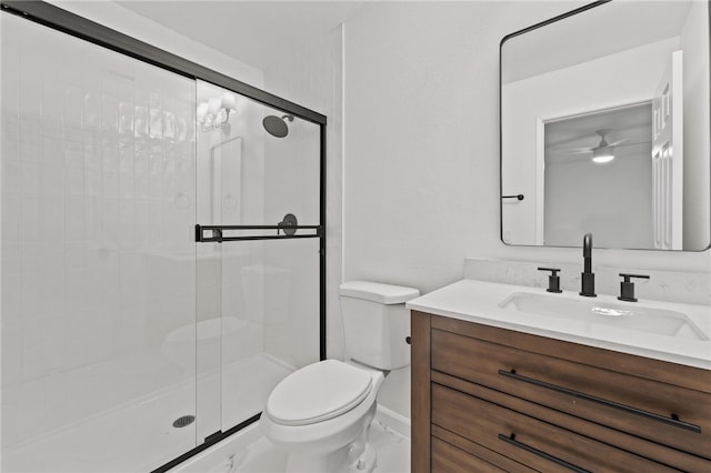 bathroom with vanity, toilet, and a shower with shower door