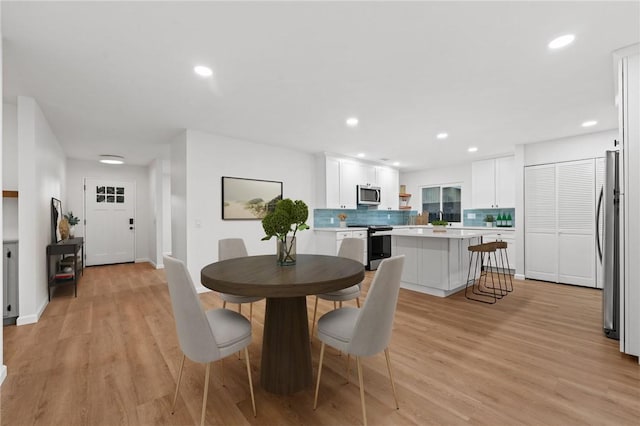 dining space with light wood-type flooring