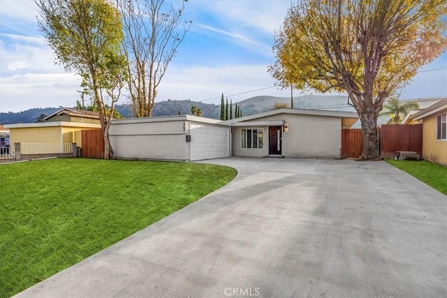 rear view of property featuring a garage and a lawn