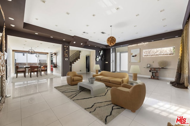 living room featuring light tile patterned flooring and a raised ceiling