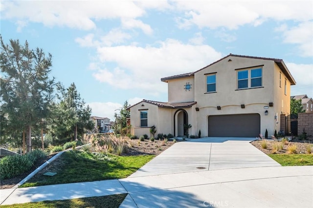 mediterranean / spanish-style home with a garage