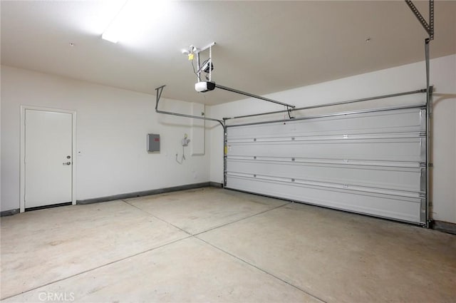 garage with a garage door opener and electric panel