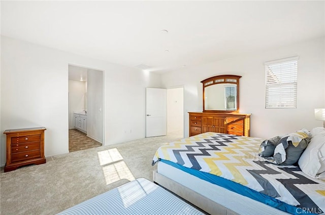 carpeted bedroom featuring connected bathroom