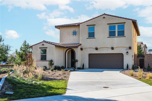 mediterranean / spanish-style house with a garage