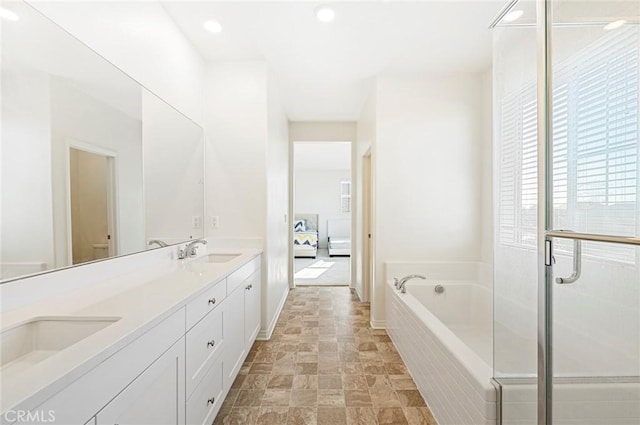 full bathroom featuring toilet, separate shower and tub, and vanity