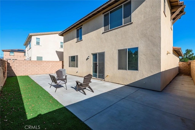 back of property with a patio