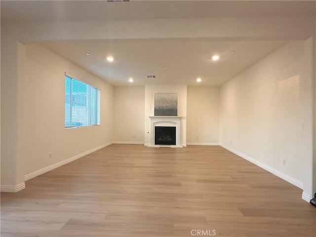 unfurnished living room with light hardwood / wood-style flooring