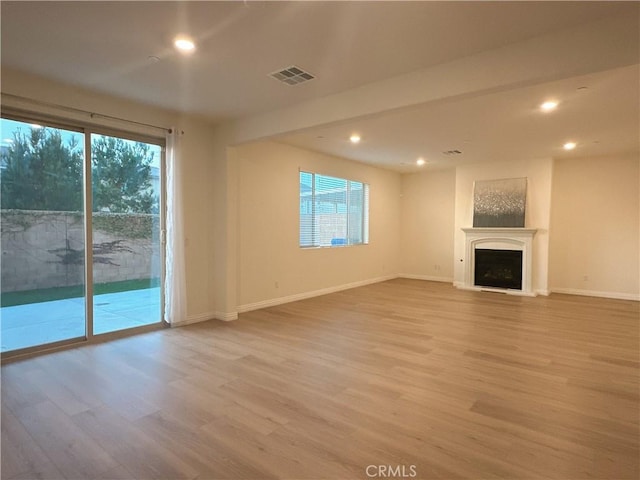 unfurnished living room with light hardwood / wood-style flooring