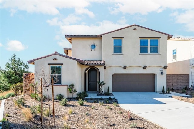 mediterranean / spanish house with a garage