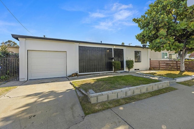 view of front of house featuring a front yard and a garage