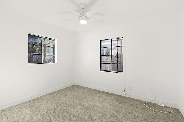 unfurnished room with ceiling fan and carpet floors