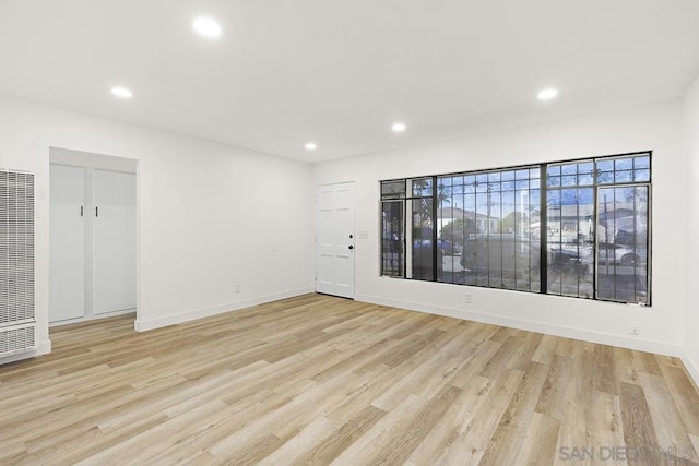 empty room with light hardwood / wood-style floors