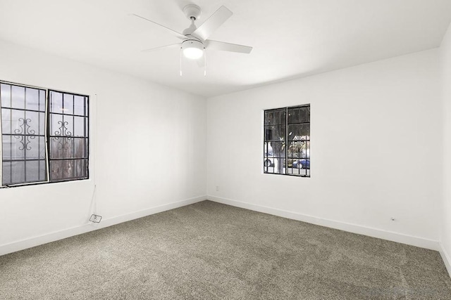 spare room with ceiling fan and carpet floors