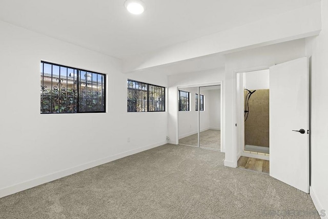 unfurnished bedroom featuring a closet and carpet flooring