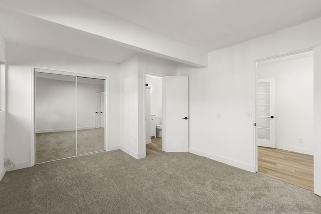 unfurnished bedroom featuring a closet and carpet floors