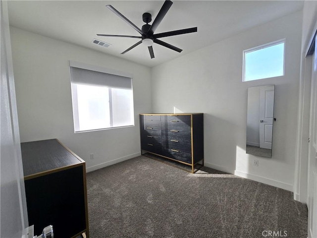 unfurnished bedroom featuring ceiling fan and dark colored carpet