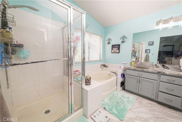 bathroom featuring vanity, lofted ceiling, and shower with separate bathtub