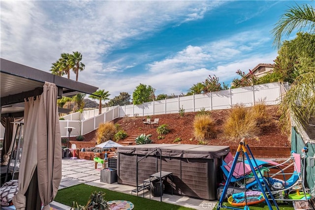 view of yard with a hot tub and a patio