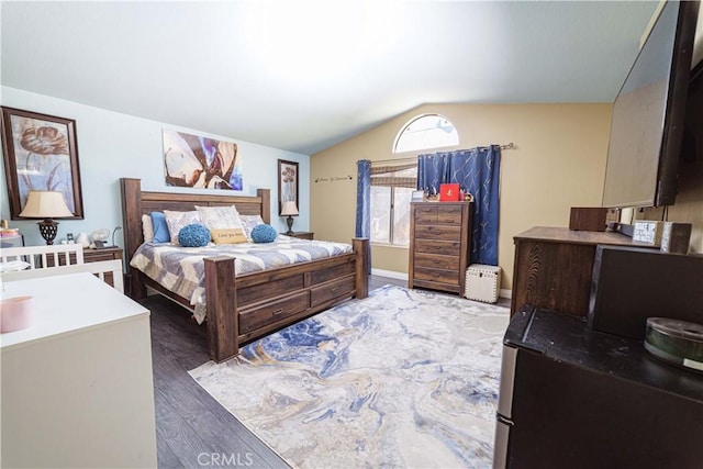 bedroom with lofted ceiling and dark hardwood / wood-style floors