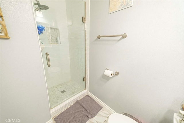 bathroom featuring toilet and walk in shower