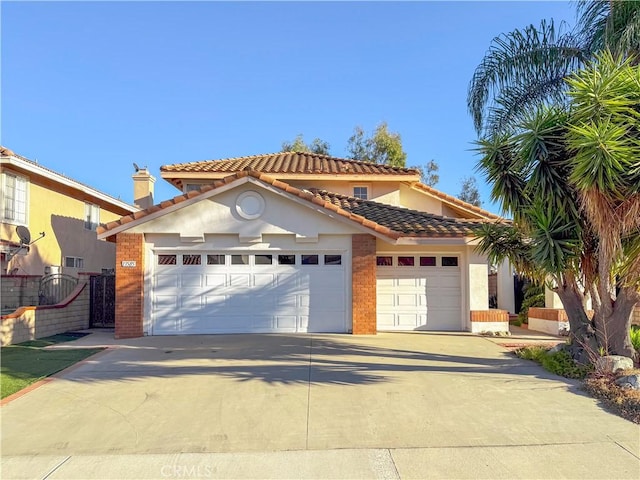 mediterranean / spanish-style house with a garage