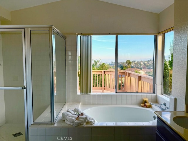 bathroom featuring vanity, vaulted ceiling, and plus walk in shower