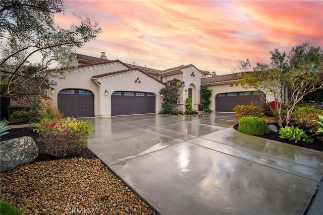 mediterranean / spanish-style home featuring a garage