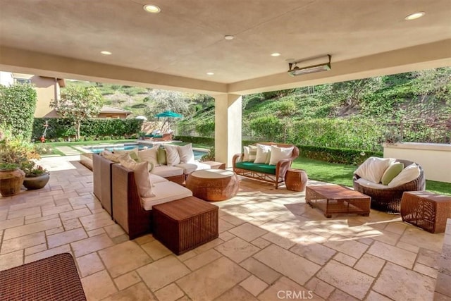 view of patio with an outdoor living space and an outdoor pool