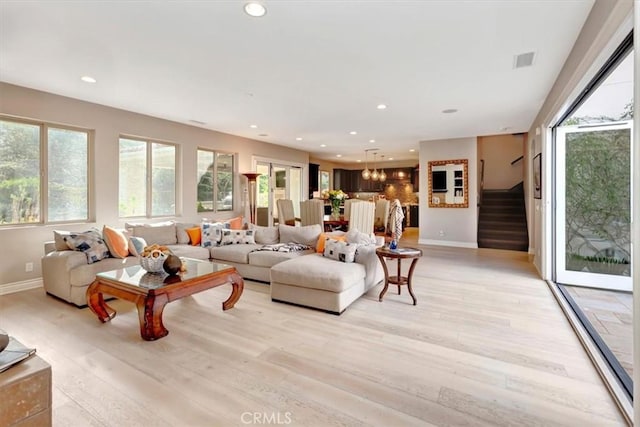 living room with light wood finished floors, stairs, visible vents, and recessed lighting