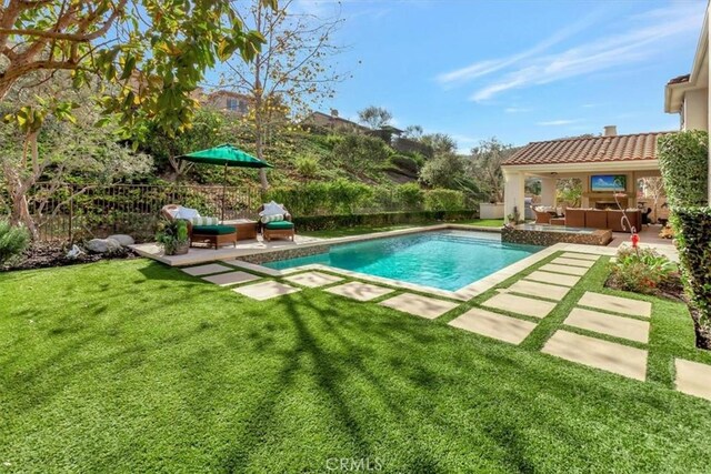 view of swimming pool featuring an outdoor hangout area, a patio area, and a lawn