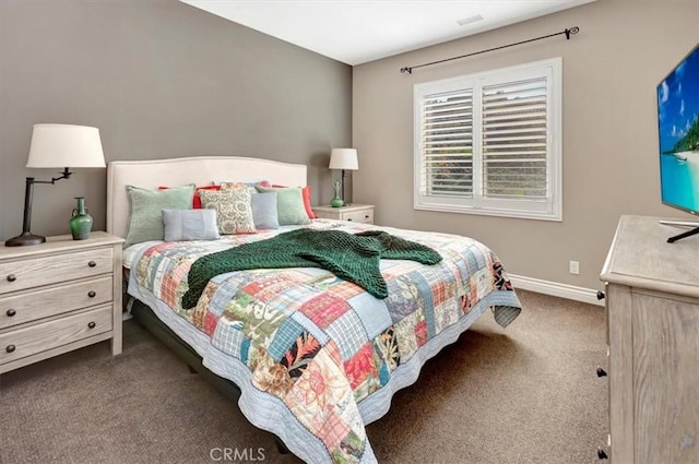 bedroom with baseboards and dark colored carpet